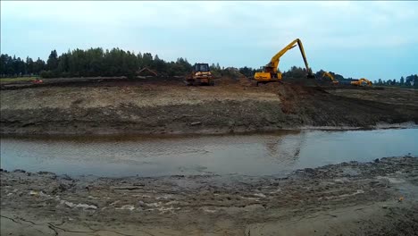 Yellow-Excavator-Works-with-Bucket-to-Clear-Mud-Sludge-and-Debris-from-the-Bottom-of-the-Drained-River