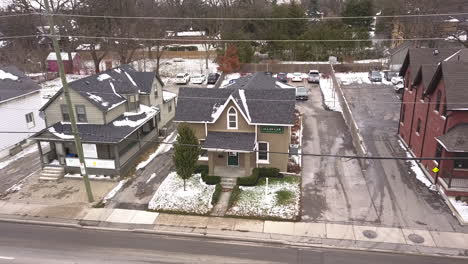 Exterior-drone-shot-of-a-small-house-in-the-winter