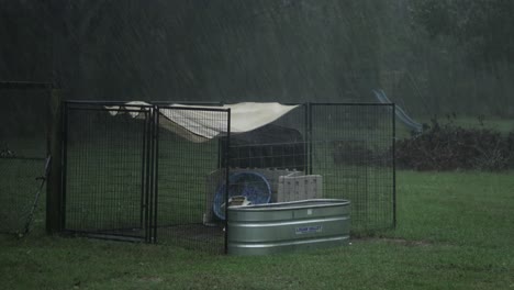 Tarp-and-other-objects-blow-around-in-the-wind-during-a-hurricane,-with-heavy-rain-in-the-country