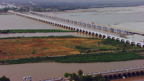 Aerial-view-of-twins-bridges,-twin-canals-both-sides-of-the-river,-big-canals-starting-from-the-river-going-between-the-city,-Traffic-is-going-on,-Khyberpakhtunkhwa,-Pakistan