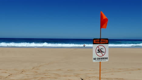 Video-footage-of-a-"No-Swimming"-sign-posted-at-the-beach-on-the-North-Shore-of-Oahu,-Hawaii
