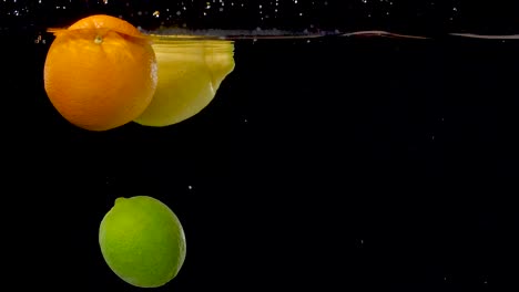 Vibrant-citrus-fruits-floating-through-water-in-slow-motion