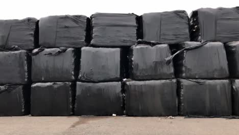 Bales-waste-wrapped-in-black-plastic