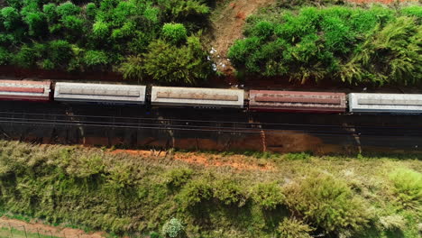 Aerial-video-following-a-train-crossing-fields,-Campinas,-São-Paulo,-Brazil