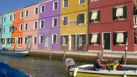 Boat-crossing-the-canal-in-Burano,-Venice,-Italy