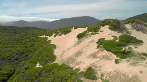 Aerial-shot-of-sand-dunes-and-big-mountains-in-Victoria-Australia