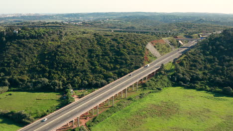 Aerial:-A-highway-going-through-the-country-side-of-the-Algarve-in-Portugal