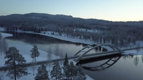A-bridge-in-a-rural-frozen-landscape-of-Sweden,-during-winter