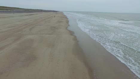 Aerial:-An-overcast-day-at-the-sand-beach-between-Domburg-and-Westkapelle,-the-Netherlands