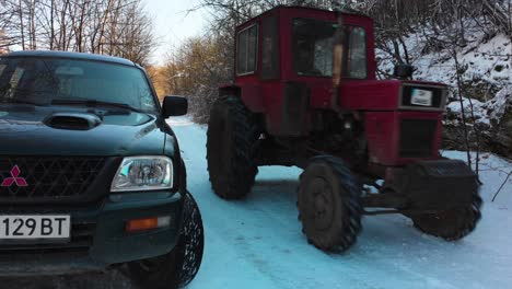 Tractor-pass-next-to-pick-up-track-in-winter-day