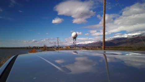A-hyper-lapse-driving-away-from-a-radar-tower-in-the-middle-of-the-country