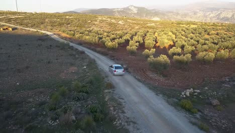 Aerial-tracking-shot-following-a-car-in-the-countryside