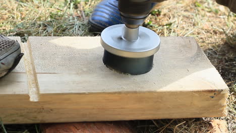 Person-is-Drilling-a-Hole-in-a-Wooden-Plank-With-Electrical-Jigsaw