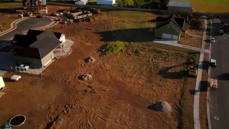 A-drone-shot-spinning-around-an-empty-lot-that-awaits-being-dug-up-to-start-building-a-new-home
