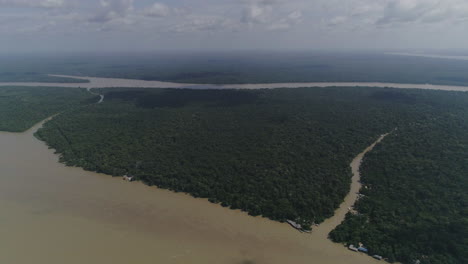 Amazonian-huge-river-with-affluents-inside-jungle,-very-high-aerial-shot-showing-horizon