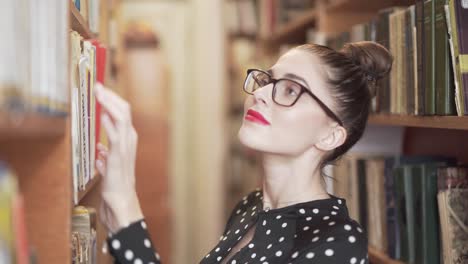 Woman-Looking-For-A-Book-In-A-Library