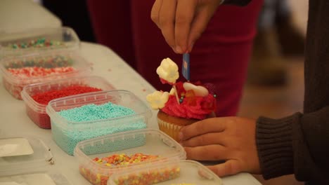 Little-boy-decorating-cupcake