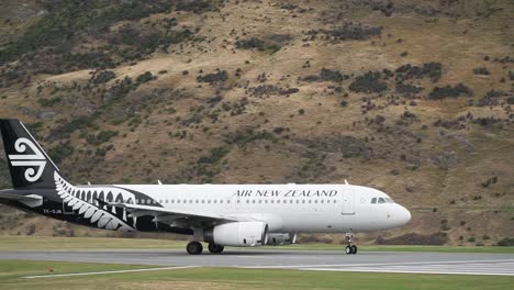 Commercial-plane-departing-from-Queenstown-Airport,-New-Zealand-with-mountains-in-background