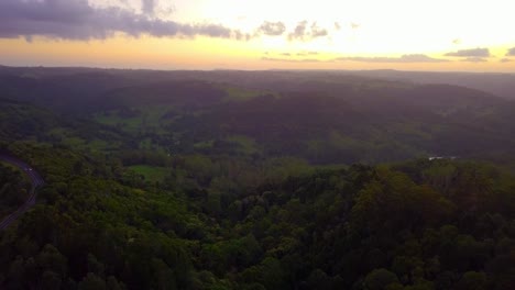 Aerial-view-of-fairytale-hills-in-a-tropical-forest-valley-at-sunset