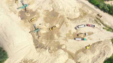 Aerial-view-loading-bulldozer-in-open-air-quarry