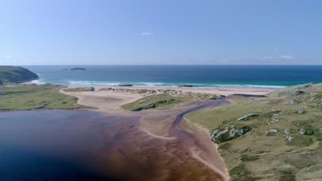 Wide-aerial-across-Sandwood-Loch-looking-out-over-the-amazing-golden-sands-of-Sandwood-Bay