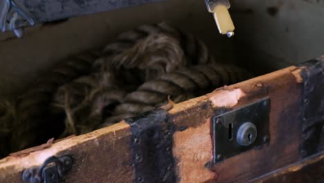 opening-a-coffer-with-ropes-inside