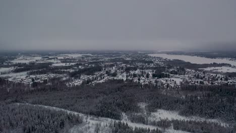 Aerial-view-of-small-town-in-snowy-cold-forest