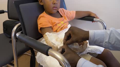 A-young-mixed-raced-child-having-a-cast-removed-from-his-arm-after-a-broken-bone-has-healed