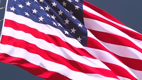 Static-slow-motion-shot,-close-up,-of-American-flag,-the-Stars-and-Stripes,-waving-in-the-wind,-in-United-states-of-America