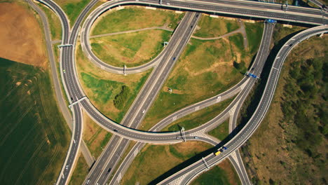 Aerial-top-down-view-on-multilevel-interchange-overpass-in-Zbraslav-showing-afternoon-traffic-under-sun-and-cloud