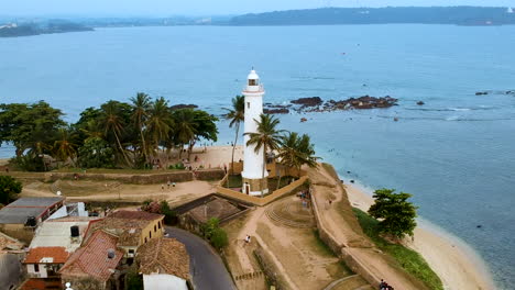 Aerial-drone-of-Galle-fort-Lighthouse-at-sunset-golden-hour
