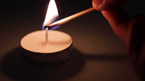 A-small-candle-being-lit-with-a-match