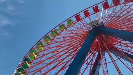 Giant-Ferris-Wheel-multicolored-with-a-blue-sky-background-low-angle-view-4K