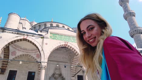 Attractive-beautiful-girl-in-shirt-takes-selfie-with-view-of-Sultan-Ahmet-Mosque-in-Istanbul,Turkey