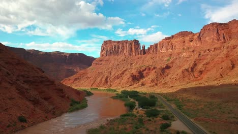 Drone-shot-of-the-Colorado-River-flowing-through-a-red-rock-canyon-in-Utah