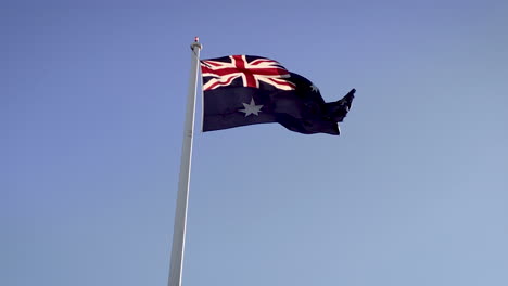Australian-"Aussie"-flag-waving-in-the-wind,-Toowoomba-Queensland