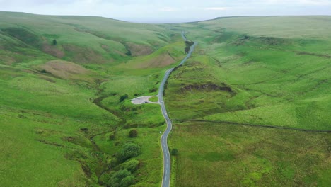 A-long-road-leading-up-into-green-hills-and-countryside