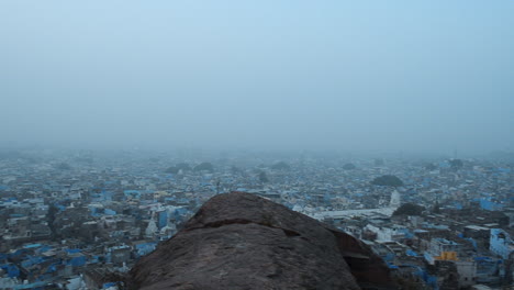 Birdseye-ariel-view-of-blue-city-of-Jodhpur-Rajasthan-India-at-the-misty-winter-morning-panning-shot