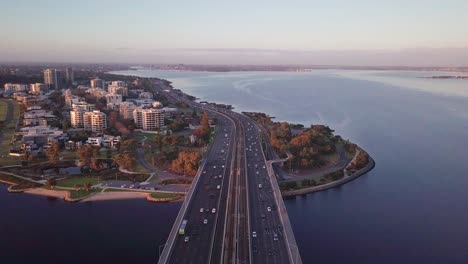 Aerial-view-from-above-the-narrows-bridge-showing-busy-morning-commute-in-Perth,-Western-Australia-with-forward-camera-motion