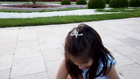 Slow-motion:little-girl-tries-to-walk-funny-in-garden-or-park