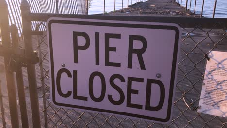Pier-closed-signs-of-danger-where-a-beach-is-not-safe-and-falling-into-disrepair