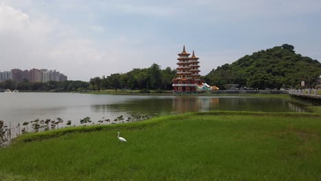 Panorama-of-the-Dragon-and-Tiger-Pagodas-at-Lotus-Pond-with-a-stork-in-the-foreground