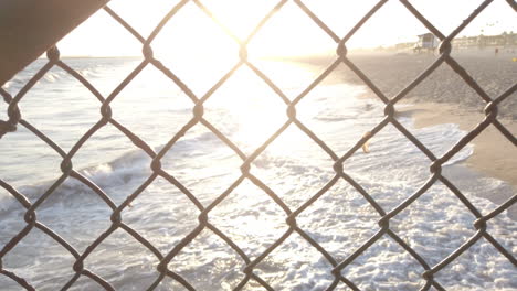 Sunset-beach-through-chainlink-fence