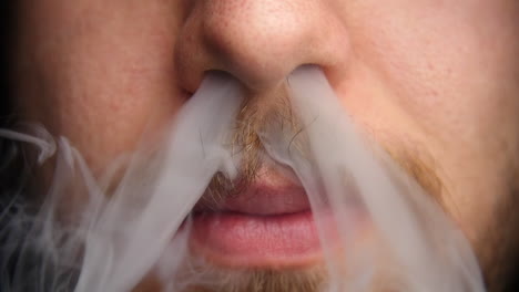 Man-exhales-vapor-through-his-nose-in-slow-motion