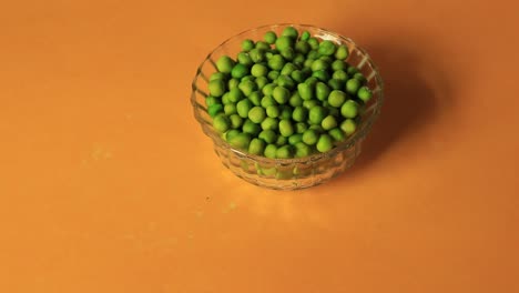 A-bowl-full-of-green-peas-on-red-background