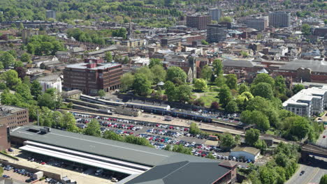 Wide-Static-aerial-view-of-commuters-boarding-a-train-in-Maidstone-East-train-station-in-Maidstone,-Kent,-UK