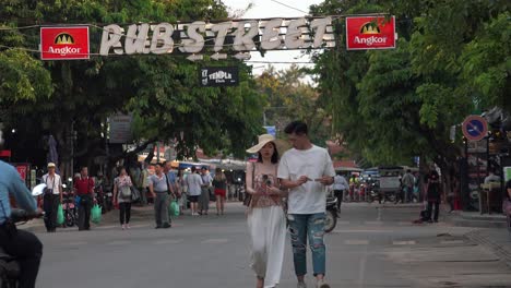 Young-Chinese-Couple-Walking-on-Pub-Street-in-the-Day-Time