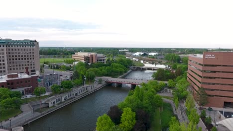 A-drone-shot-captures-footage-flying-north-over-Saginaw-Street-and-the-Flint-River-in-Flint,-Michigan