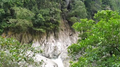 Wawa-river-tilting-shot-reaveling-limestone-cave-on-foothills-of-the-mountain