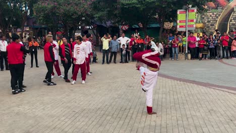 Young-asian-boy-doing-performing-streetdance-breakdance-in-public-while-others-are-cheering-up-for-him-in-Adlabas-Imagica-Amusement-Theme-park-in-India